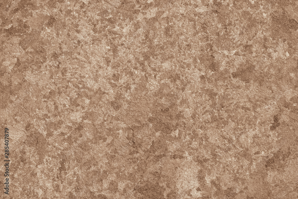 Fototapeta premium Old paper wall texture in spots. Abstract brown cardboard sheet background. Decorative uneven pattern. Aged dirty paper sheet. Copy space, yellow painted rough surface of parchment.
