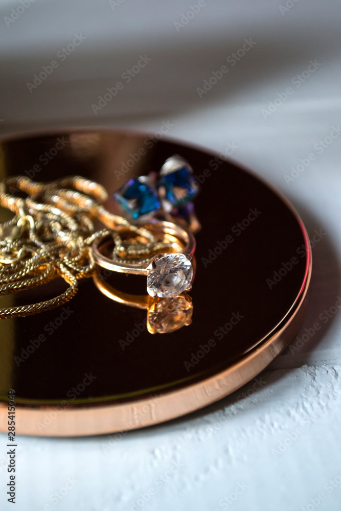 Golden ring with diamonds. Female jewelry on a table, close up. Golden ring with diamonds. Female jewelry on a table, close up.