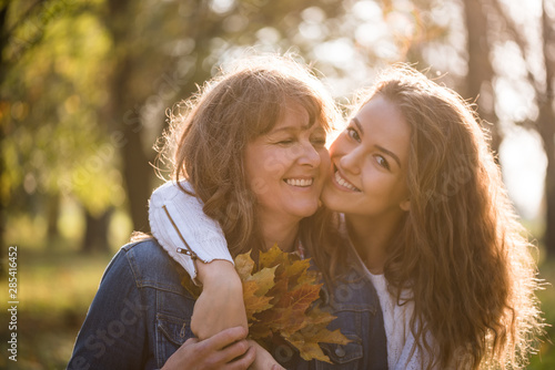 Daughter hugging her mother in nature