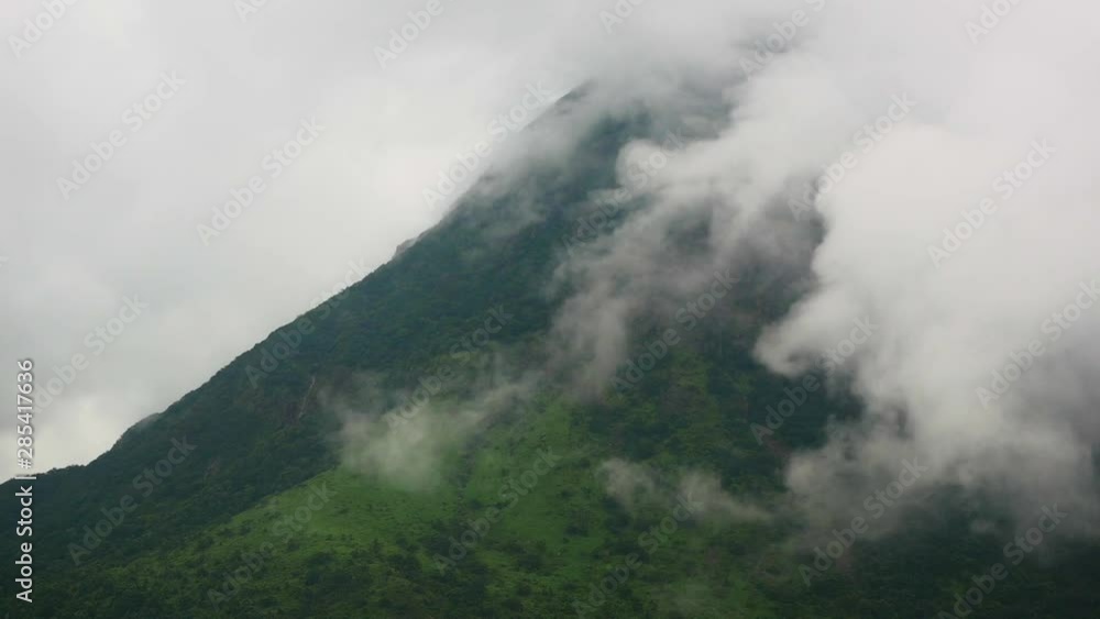 A timelapse of clouds on a green mountain. A timelapse of clouds on a green mountain.