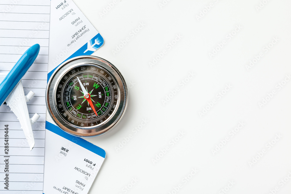 Time to Travel. Idea for tourism with flight tickets and compass on white