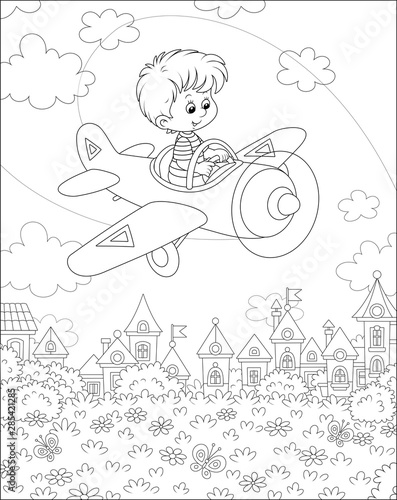 Little boy piloting his sma...