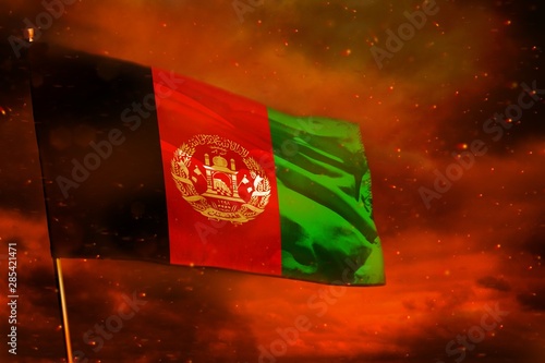 Fluttering Afghanistan flag on crimson red sky with smoke pillars background. Troubles concept.