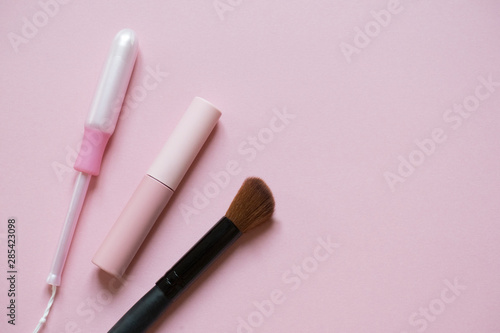 Beautiful flatlay of cosmetics and women's accessories on pink with place for text. Makeup, femininity, fashion, hygiene concept