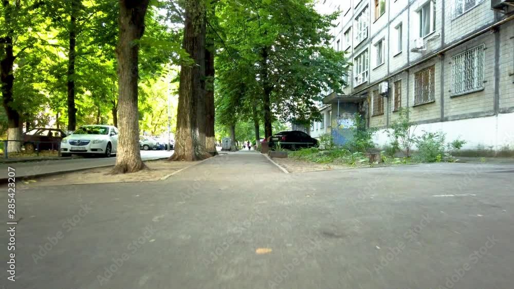 Push-in low shot of a sidewalk in a residential area Push-in low shot of a sidewalk in a residential area