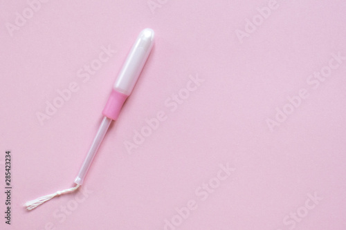 Tableau sur toile Medical female tampon with applicator on pink with place for text