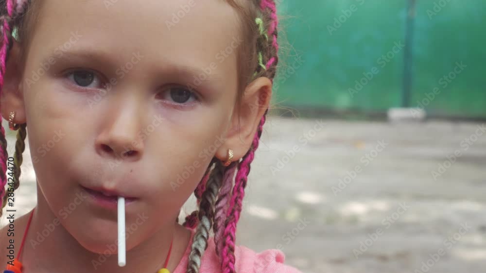Portrait of a little girl with dreadlocks in a rural yard Portrait of a little girl with dreadlocks in a rural yard