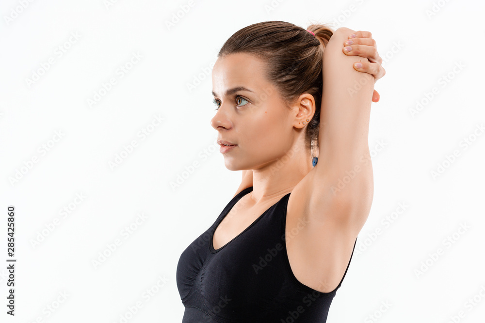 Young sporty blond woman in a black sportswear stretching before exercising isolated over white background. Young sporty blond woman in a black sportswear stretching before exercising isolated over white background.
