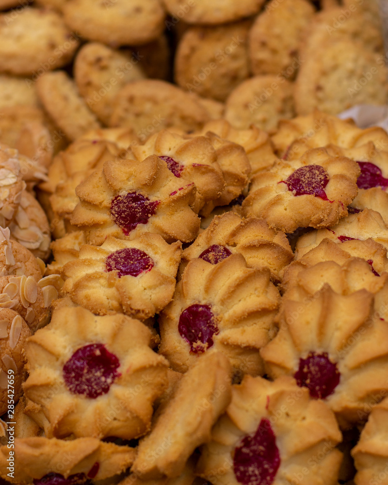 Shortbread cookies with a drop of jam, curabier dessert vertical background Shortbread cookies with a drop of jam, curabier dessert vertical background