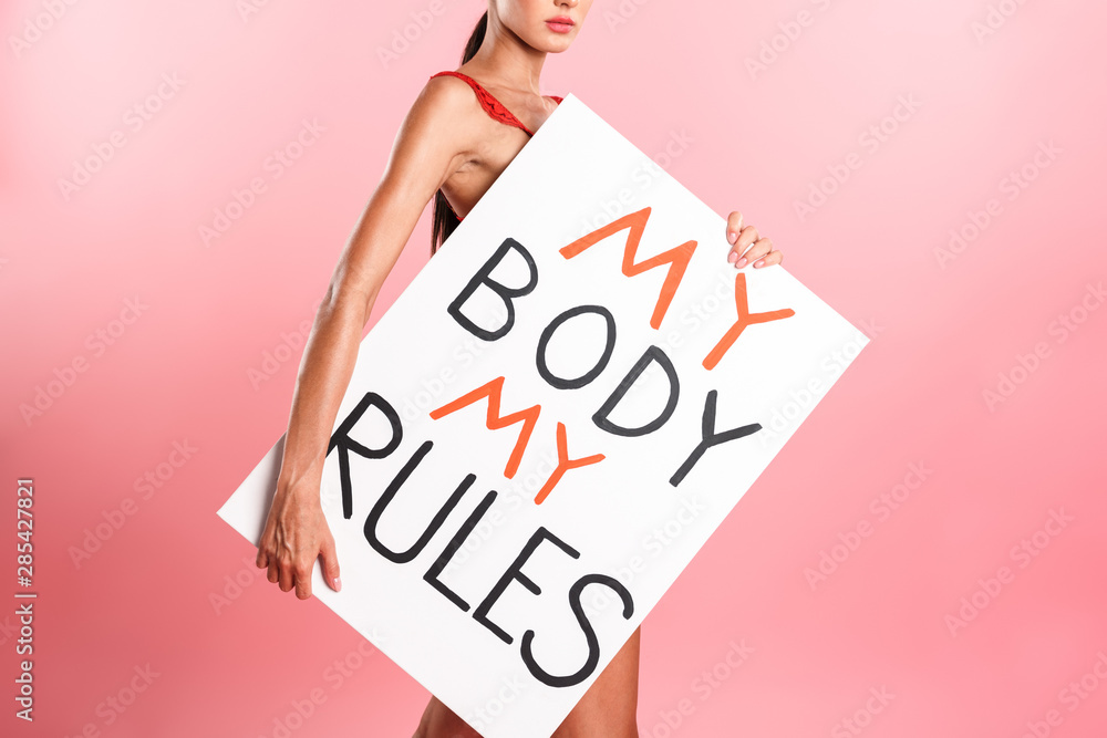 Image cropped of nice serious woman wearing white sexual lace lingerie holding placard with text isolated Image cropped of nice serious woman wearing white sexual lace lingerie holding placard with text isolated