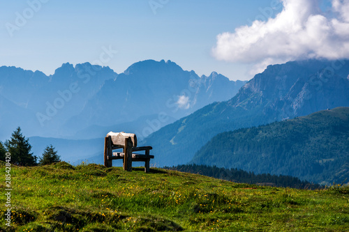 A bench in the meadow in mountains, South Tyrol.