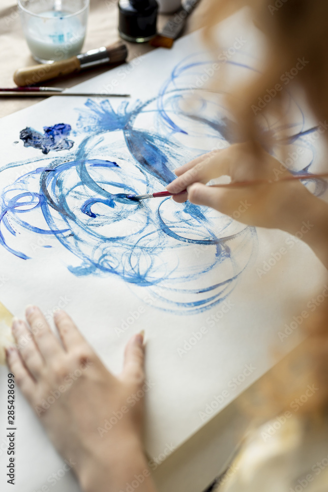 Close-up woman using blue paint Close-up woman using blue paint