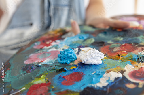 Close-up person holding painting palette