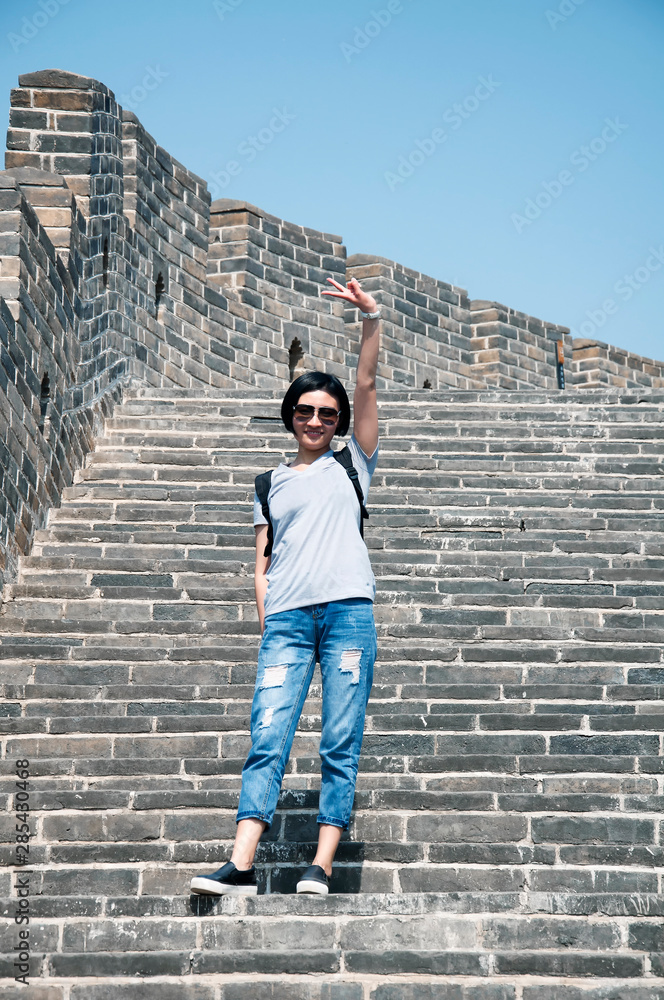 a chinese woman flashing a victory sign in china