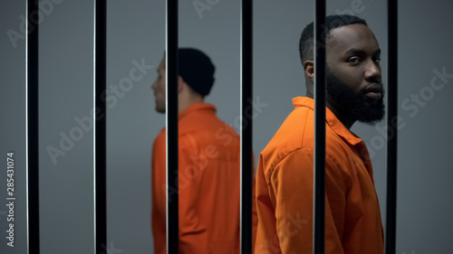 Prisoners walking in jail cell, long imprisonment, feeling hope for freedom