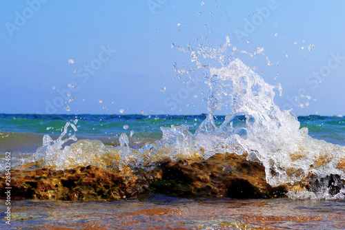 wave splashing on stones on beach