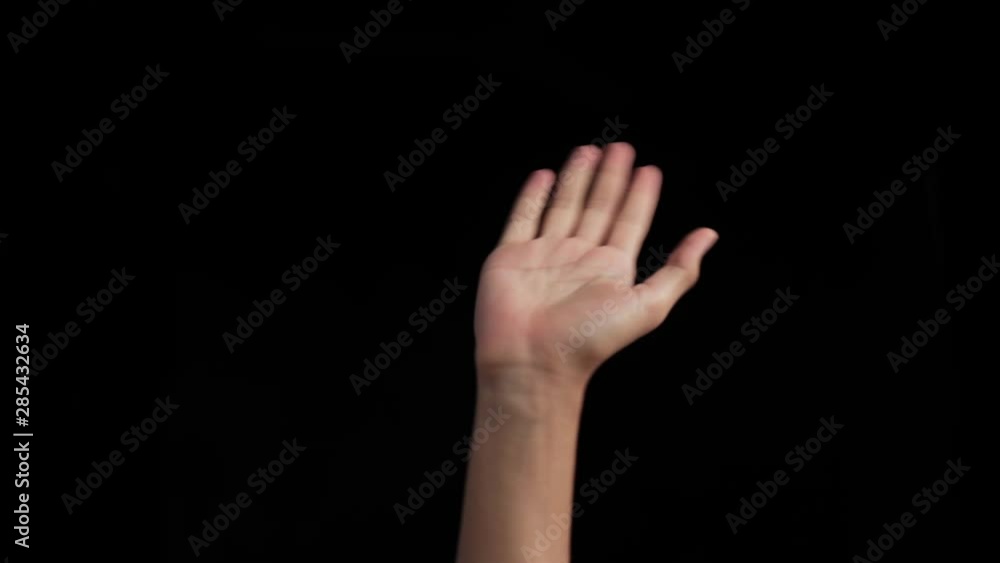 Human hand coming up with a paper plane and playing with it isolated on a black colored background. Human hand coming up with a paper plane and playing with it isolated on a black colored background.