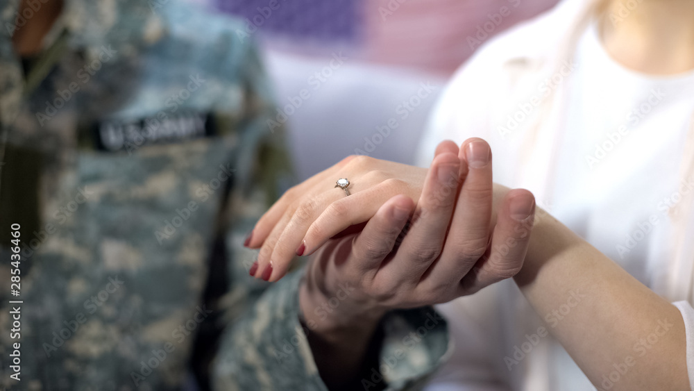 Military officer holding girlfriend hand with engagement ring, proposal close up Military officer holding girlfriend hand with engagement ring, proposal close up
