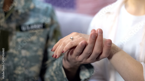 Fotografija Military officer holding girlfriend hand with engagement ring, proposal close up