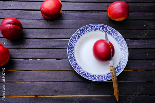 Bunch of ripe nectarines on a wooden table
