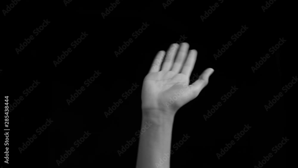 Human hand coming up with a paper plane and playing with it isolated on a black colored background. Human hand coming up with a paper plane and playing with it isolated on a black colored background.