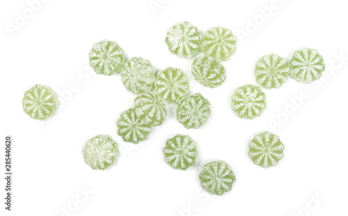 Green hard menthol candies isolated on white background, top view