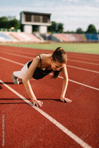 Girl athlete wrung out on the field on a sunny day