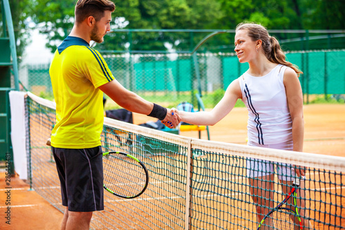 Tennis players shake hands after match. © Dmytro Panchenko