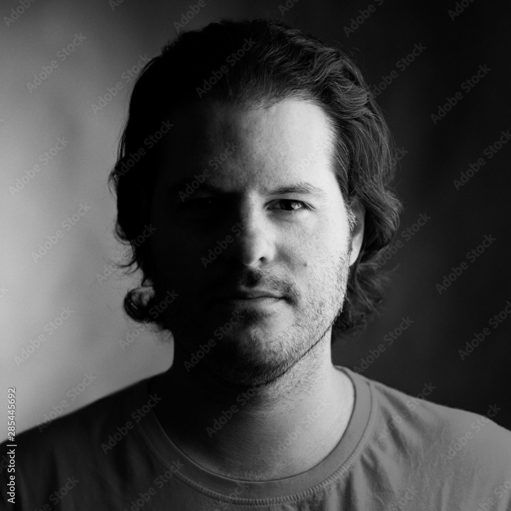 Fototapeta premium Portrait of a man shot on analog medium format film. Analogue film photography and grain concept.