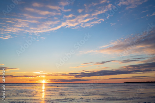 The sun setting over a frozen harbor in rural Prince Edward Island, Canada.......