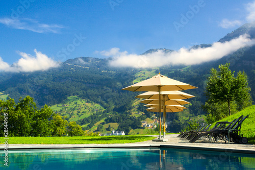 Fototapeta Naklejka Na Ścianę i Meble -  Luxury resort with pool overlooking the mountains, Switzerland.
