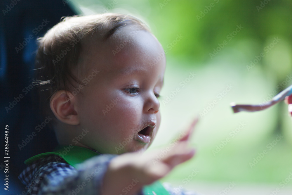 Mother feeding baby. Babies and children will start eat food to get nutrition for developing brains, digestive, and immune systems Mother feeding baby. Babies and children will start eat food to get nutrition for developing brains, digestive, and immune systems