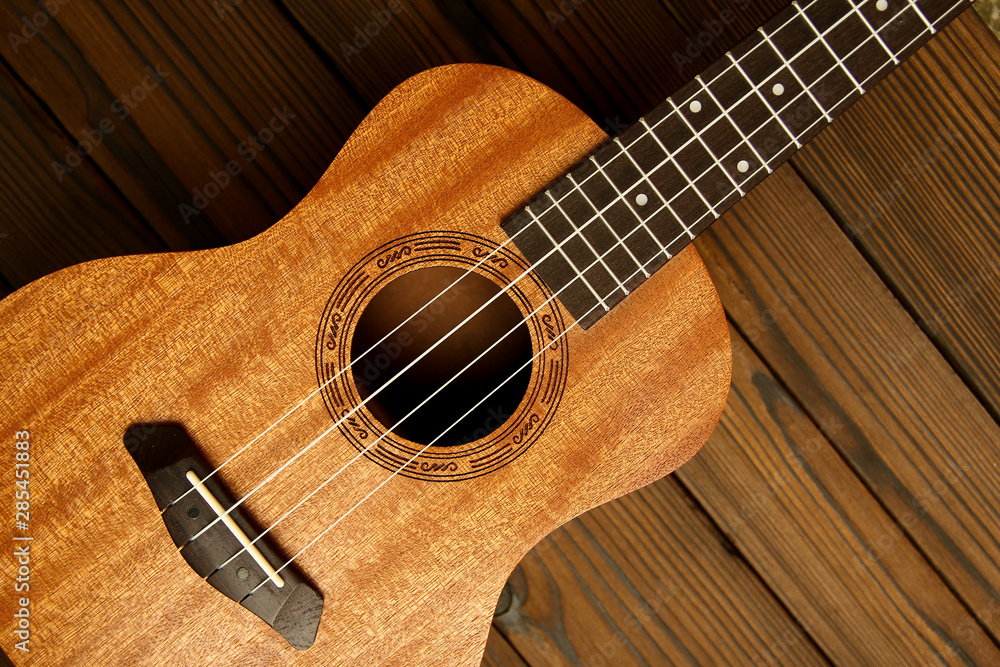 Fototapeta premium Ukulele on wooden background