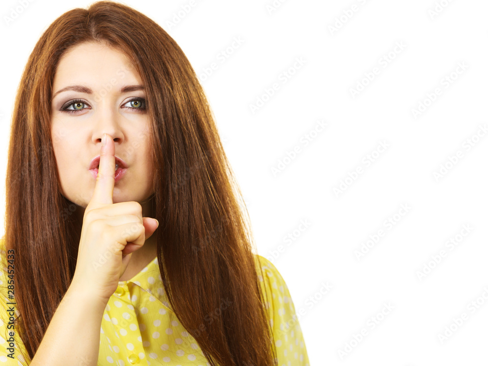 Woman asking for silence with finger on lips Woman asking for silence with finger on lips