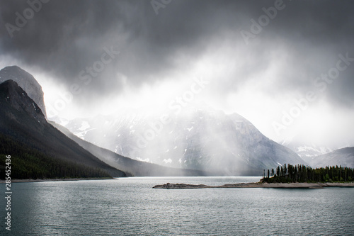 Hiking under the clouds and rain at the Upper Kananaskis Lake in the Canadian Rockies in Alberta