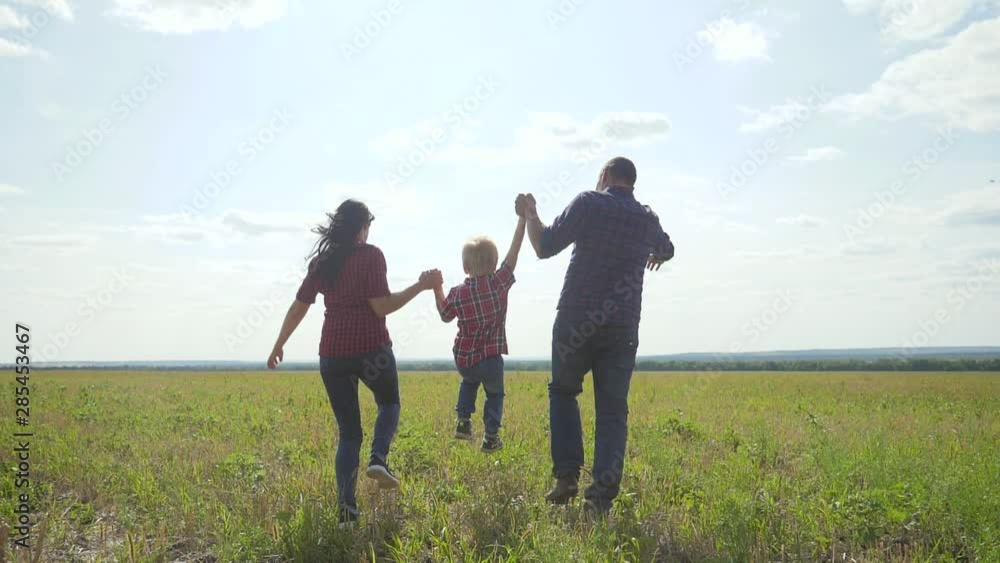 happy family runs nature teamwork friendship care concept slow motion video. father mom and son running in nature sunset sunlight hold hand. happy family parents man and girl lifestyle hold little boy happy family runs nature teamwork friendship care concept slow motion video. father mom and son running in nature sunset sunlight hold hand. happy family parents man and girl lifestyle hold little boy
