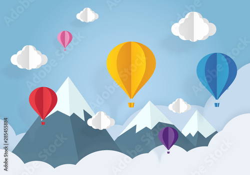 Air balloons in the blue sky with white clouds paper cut. Paper art and origami style.