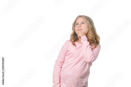 Portrait of a blonde little girl pensive on the white background
