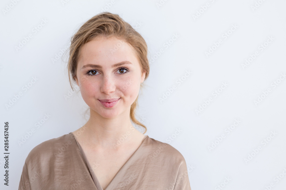 Attractive, beautiful young girl with brown hair on a white background. The concept of student life, youth. Attractive, beautiful young girl with brown hair on a white background. The concept of student life, youth.
