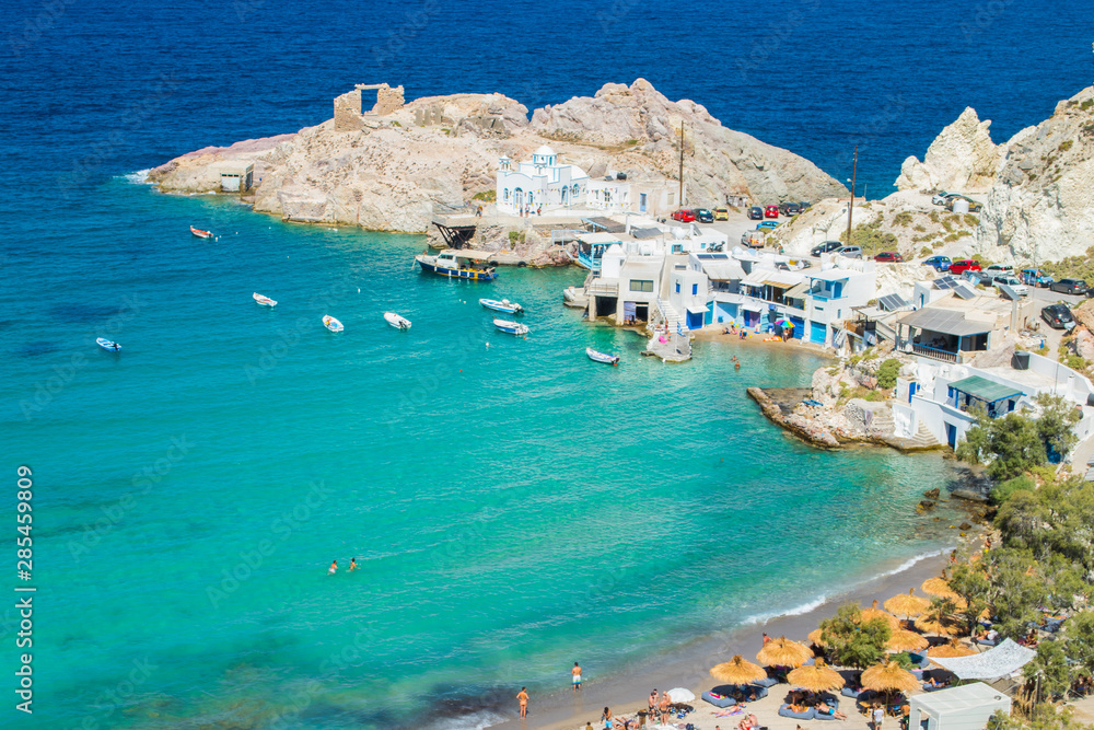 Panoramic view of the beach of Firopotamos village eith the turquoise waters and the colorful fishing houses