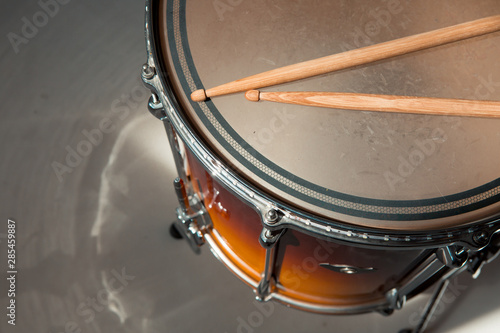 percusions drums with drumsticks on it close-up