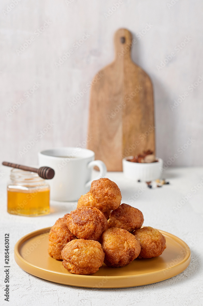 Cottage cheese balls doughnuts is jam-packed with jelly filling, cup of tea and honey