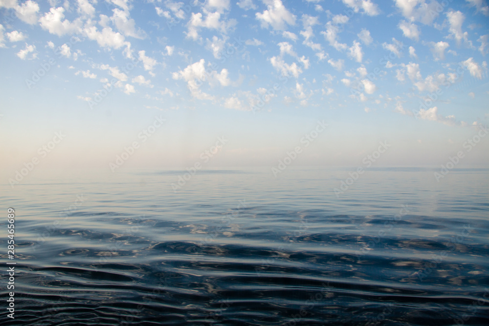 Blue seawater surface with clouds in the sky, Venice