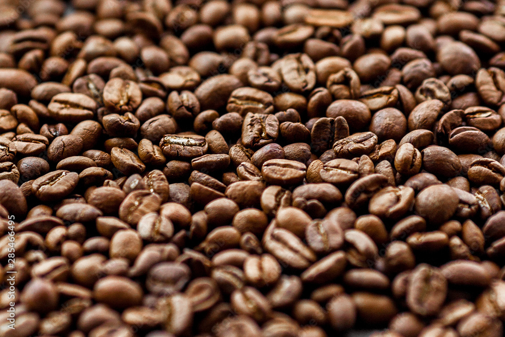 Roasted coffee beans heap background Roasted coffee beans heap background