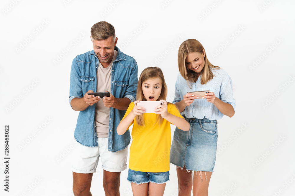 Cheerful family wearing casual outfit standing isolated Cheerful family wearing casual outfit standing isolated