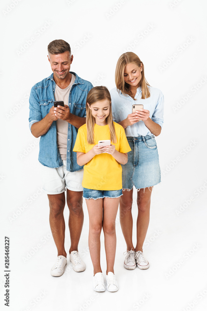 Cheerful family wearing casual outfit standing isolated Cheerful family wearing casual outfit standing isolated