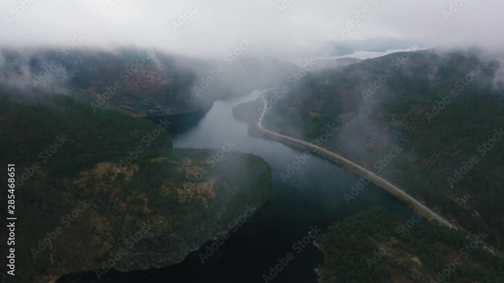 Aerial view of road in Norway with forest, lake, mountains, clouds in 4K Aerial view of road in Norway with forest, lake, mountains, clouds in 4K