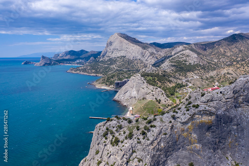 Panoramic view towards Green bay of Novy Svet (New World) location from top of Koba-Kaya Mountain, Sudak area, Crimea. Aerial drone view