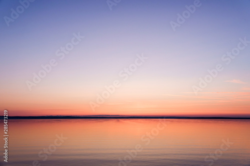 Soft dawn over the sea surface before the sun appears over the horizon on the White sea © Luidmila Spot