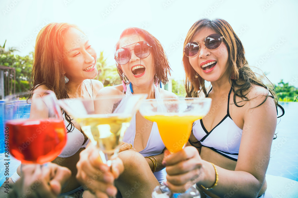 three younger asian woman happiness drinking beverage in waer swimming pool three younger asian woman happiness drinking beverage in waer swimming pool